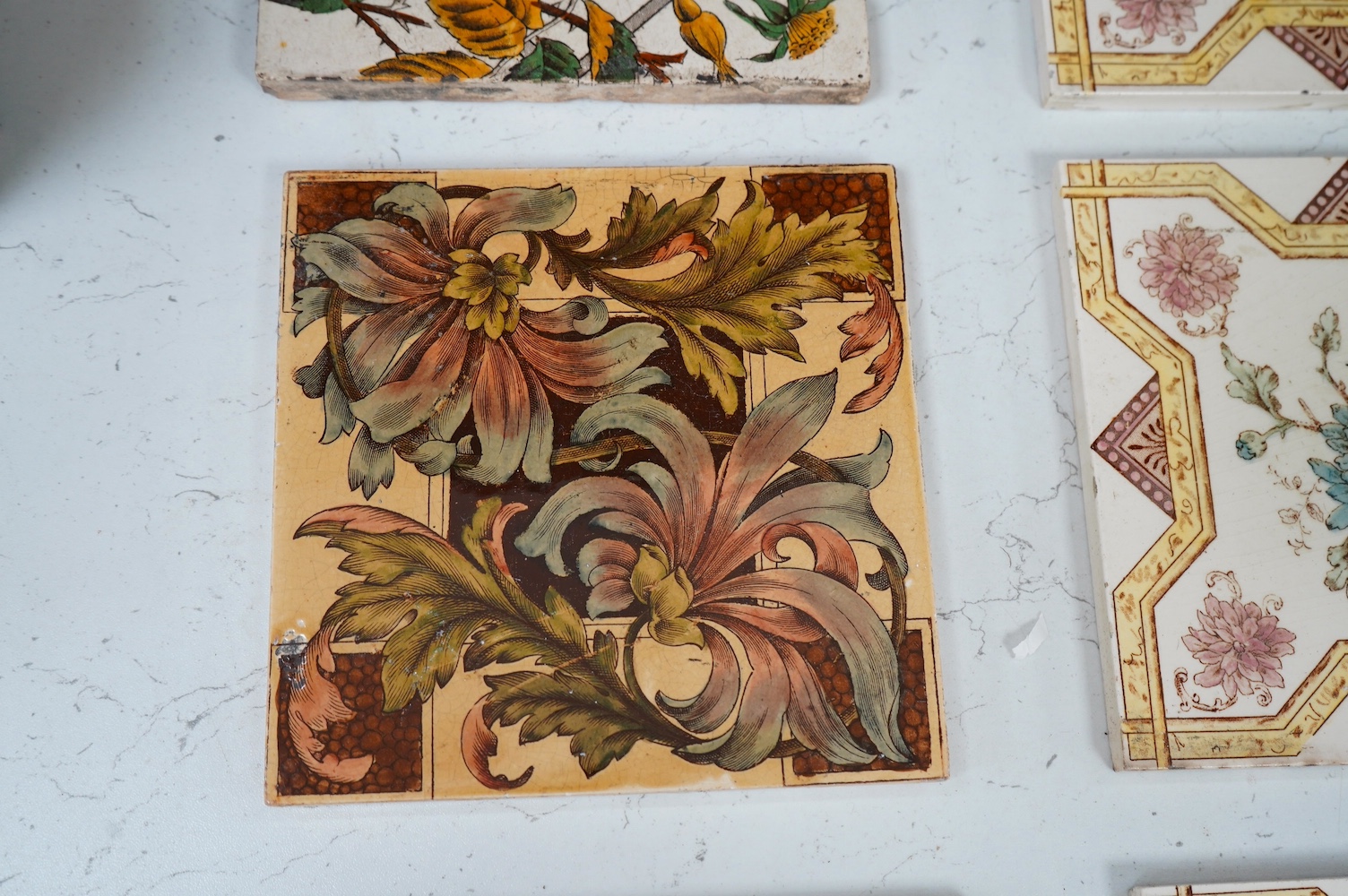 John Moyr Smith, a set of eight Waverley series Minton picture tiles to include Rob Roy and Old Mortality together with other floral tiles, largest 20 x 20cm. Condition - mostly fair, some cracked